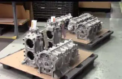Rows of engine crankcase halves on a shop bench