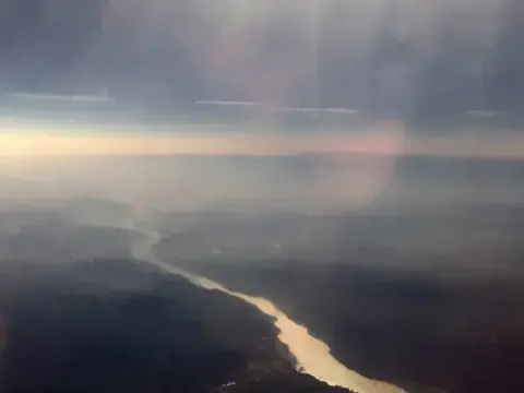 An aerial view of a winding river at low sun