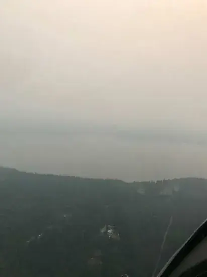 A hazy view of mountains from the cockpit