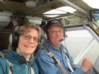 A woman and a man wearing headsets in a cockpit