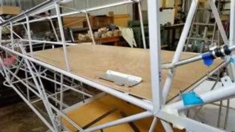 Inside a steel tube fuselage with a wooden floor panel