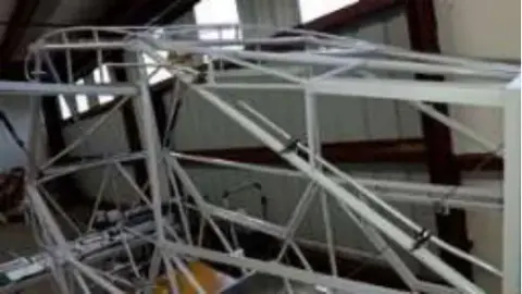 A welded steel tube frame in a workshop