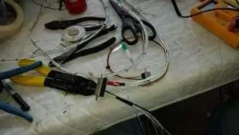 Wiring and tools on a workbench