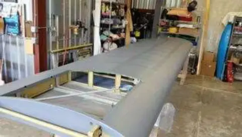 A covered wing on sawhorses in the shop