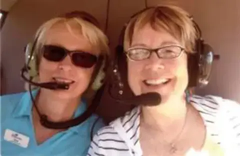 Dava & Sheree VanBerg in the back seat of a helicopter at KPWT (Bremerton National Airport)