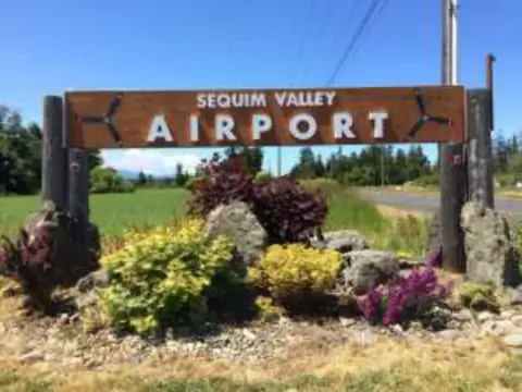 The Sequim Valley Airport entrance sign with flowers
