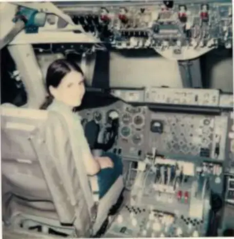Checking out a 747 simulator with her Dad
