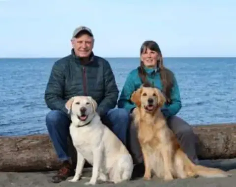 Deb & Tom with therapy dogs.