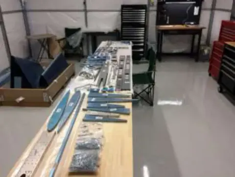 Kit parts laid out on a long workbench