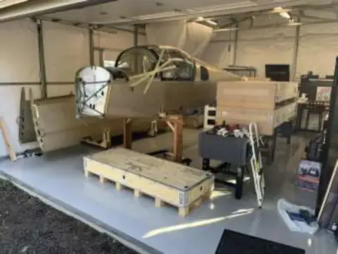 Kit parts and crates inside a workshop