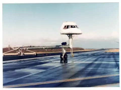 An airport control tower on a flat ramp