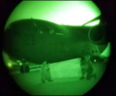 A view through night vision goggles of an airplane
