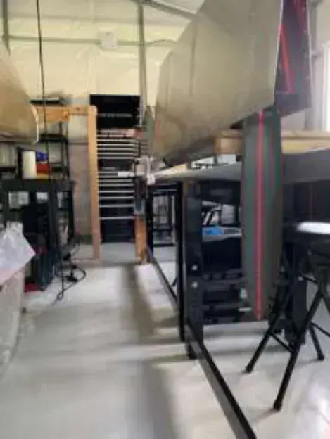 An aircraft wing on a stand in a home workshop