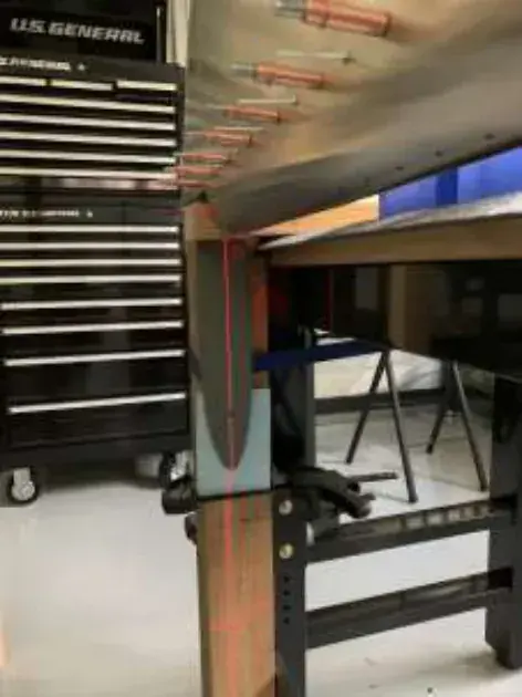 Wing ribs on a stand beside a tool chest in a workshop