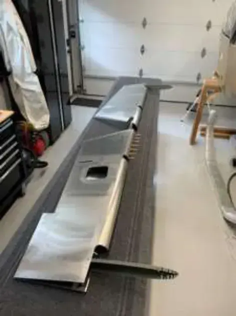 Metal aircraft wing parts on a workbench