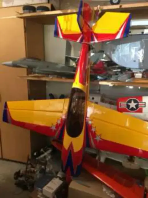 A colorful model aerobatic airplane on a shelf