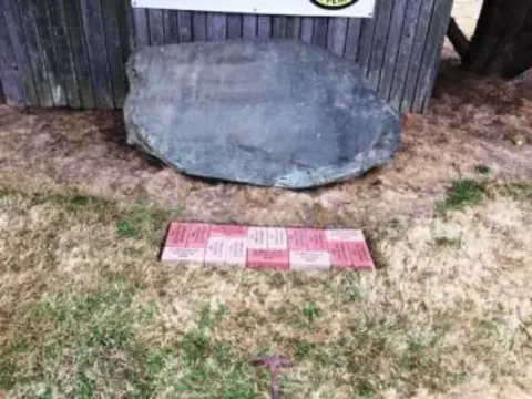 A closer view of the first engraved pavers in front of the boulder