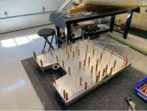 A wing jig with parts set up on a shop floor