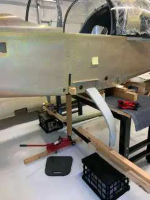 A metal fuselage section supported on a stand