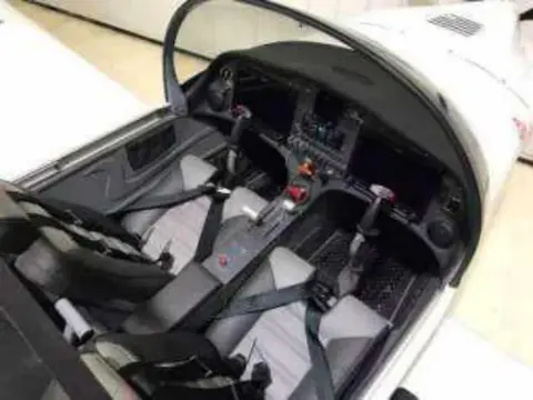 The cockpit of a white airplane under construction