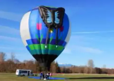 A colorful hot air balloon being inflated on a field