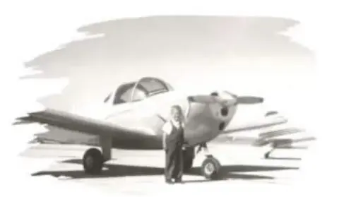 A sketch of a low-wing airplane with a man standing beside it