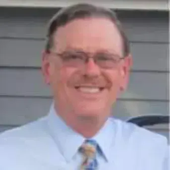Portrait of a smiling man in glasses and a tie