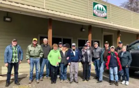 A group of fly-out members posed outside a restaurant
