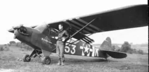 A liaison airplane marked 53 on the ground in an old photo