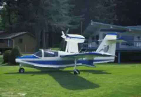A blue and white Seafire amphibian parked on a lawn