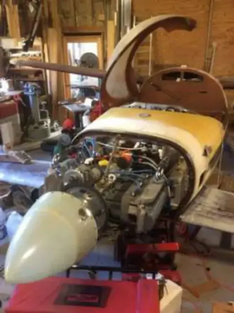 The engine and nose of a Q2 homebuilt airplane in a hangar