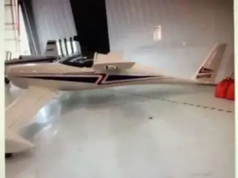 A canard homebuilt airplane parked in a hangar