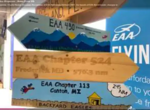 A painted signpost with arrows pointing to other EAA chapters
