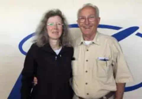A woman and a man standing in front of an EAA backdrop