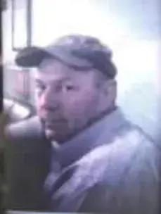 A man in a cap and a gray jacket