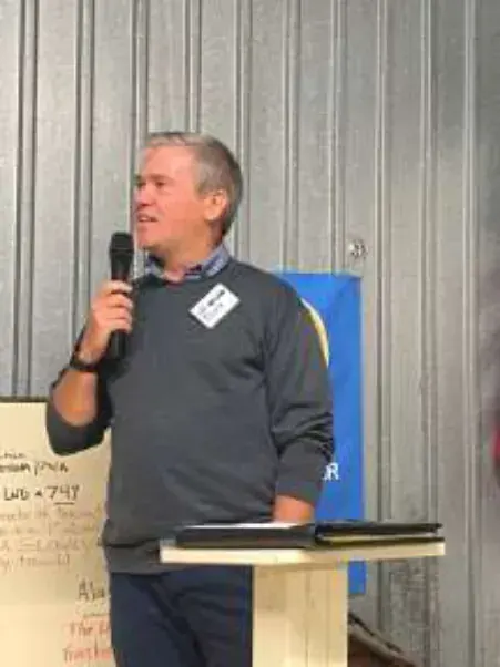 Kevin, presenter at the October gathering, explains the process of laying internet cable underwater and making repairs when necessary .