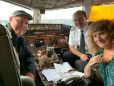 Three people in the cockpit of an airliner