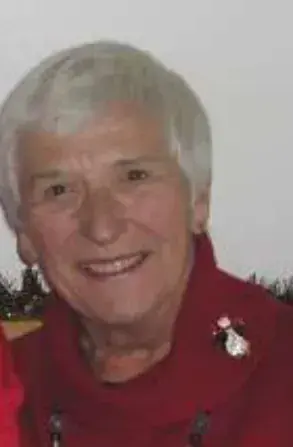 A smiling older woman with white hair