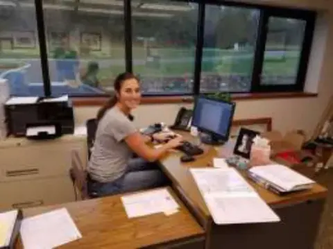 A young woman working at a desk in an office