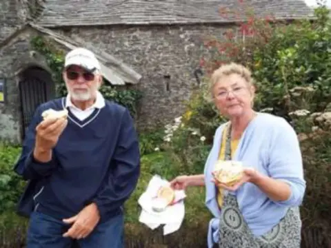 Barb & I eating scones on a visit to Cornwall in the UK