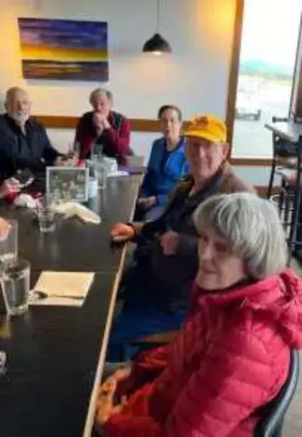 Members seated at a restaurant table