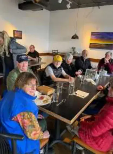 Members seated at tables in a restaurant