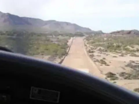 A runway seen through a windshield on approach