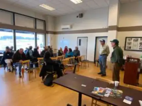 People seated in a meeting room for a presentation