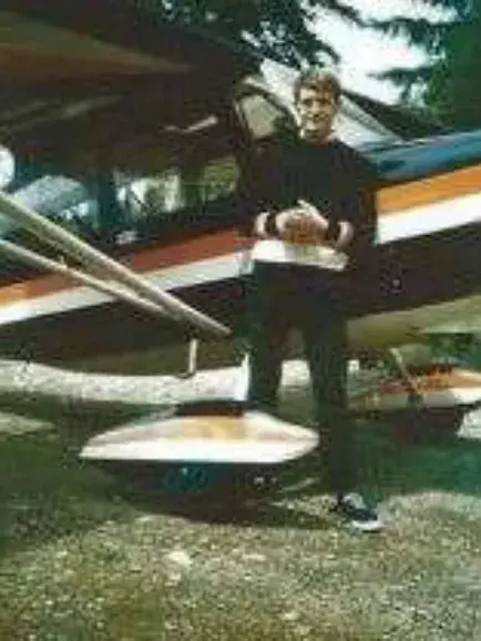 A man standing on the float of an airplane