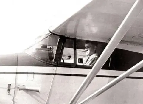 Now mission-ready in PA-22-108 Colt John preflighting Piper Colt December 1964