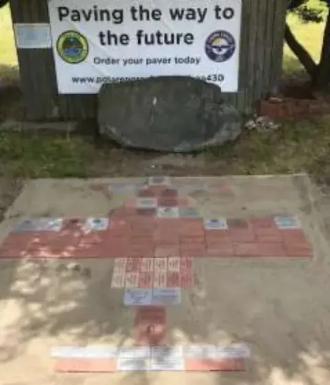 The finished brick patio beside the Paving the Way to the Future sign