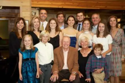A large family group posed together indoors