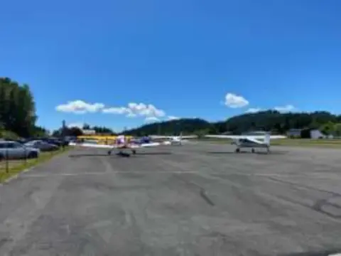 Small airplanes parked along a runway