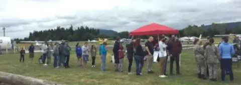 A crowd gathered on the field at the rally
